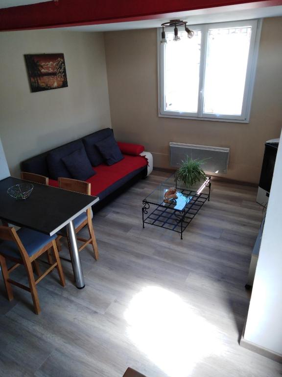 un salon avec un canapé et une table dans l'établissement Le Breuil, à Piney