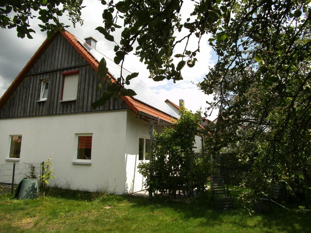 a white house with a black roof at Ferienhaus Kettler I in Muhr amSee