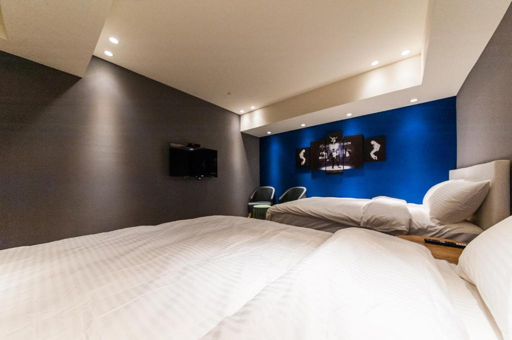 Postel nebo postele na pokoji v ubytování Talent Hotel