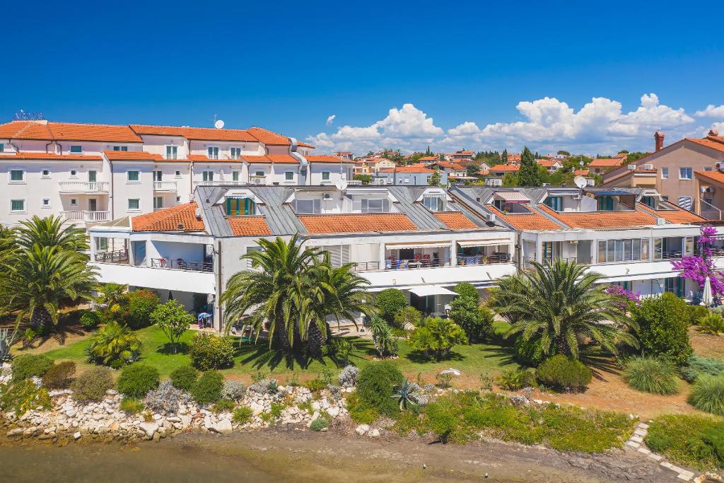 an aerial view of a building with palm trees at Apartments Villa Ana in Medulin