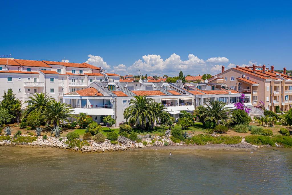 a group of buildings next to a river at Apartments Villa Ana in Medulin