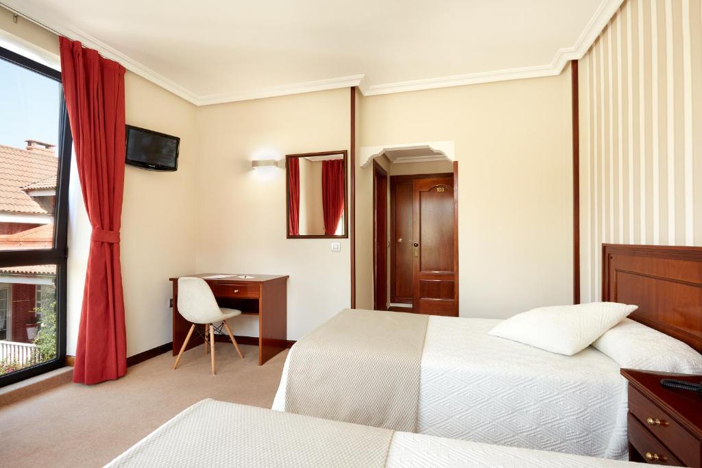 Postel nebo postele na pokoji v ubytování Hotel Piedras