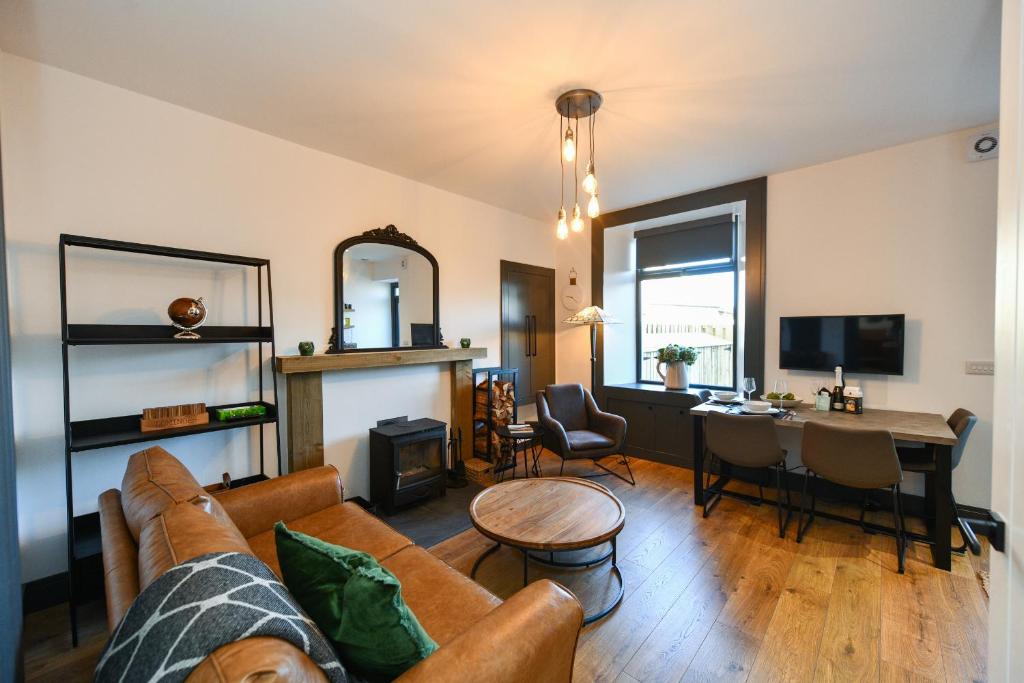 a living room with a couch and a table at South Shores Cottage Flat in Troon