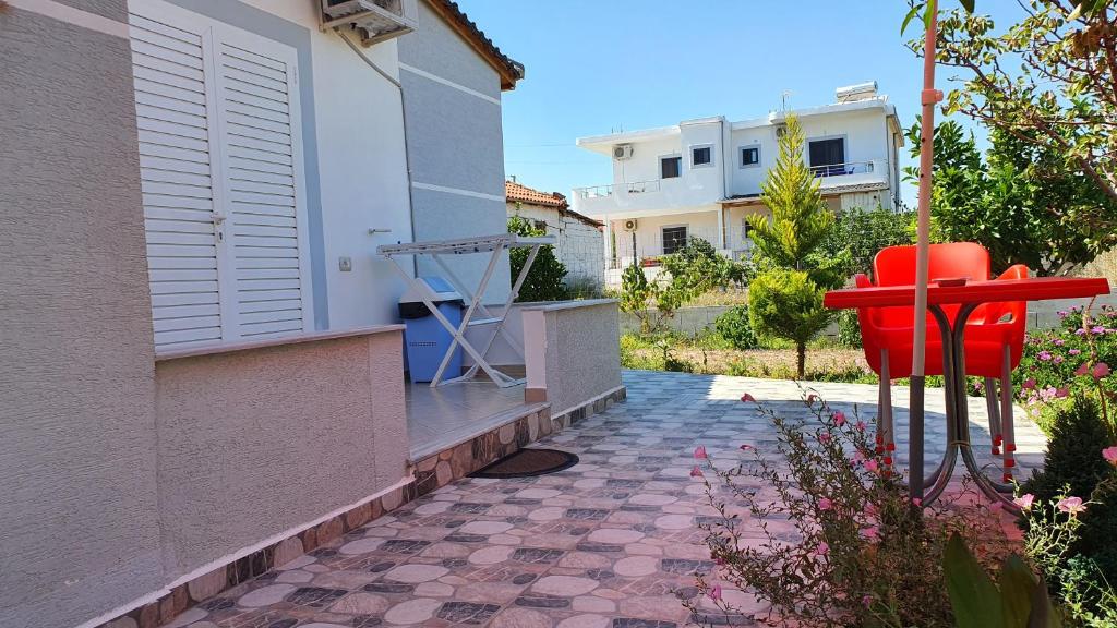 a red object sits outside of a house at Villa Denis Ksamil in Ksamil