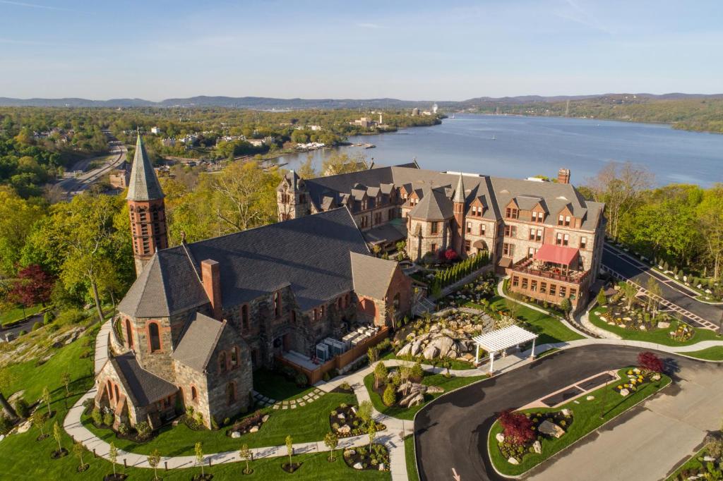 an aerial view of a mansion with a church at The Abbey Inn & Spa in Peekskill