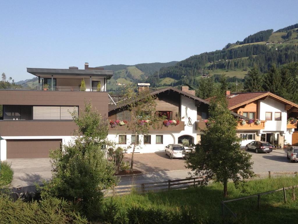 a building with cars parked in a parking lot at WOHNEN by LIZZY in Wagrain