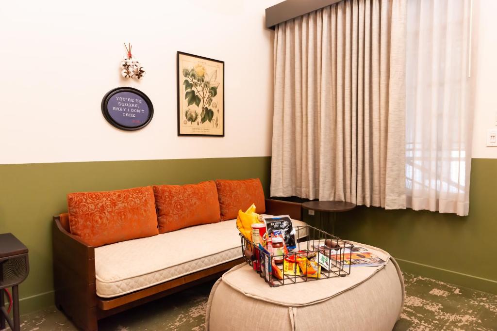 a living room with a couch and a table at Cotton Court Hotel, by Valencia Hotel Collection in Lubbock