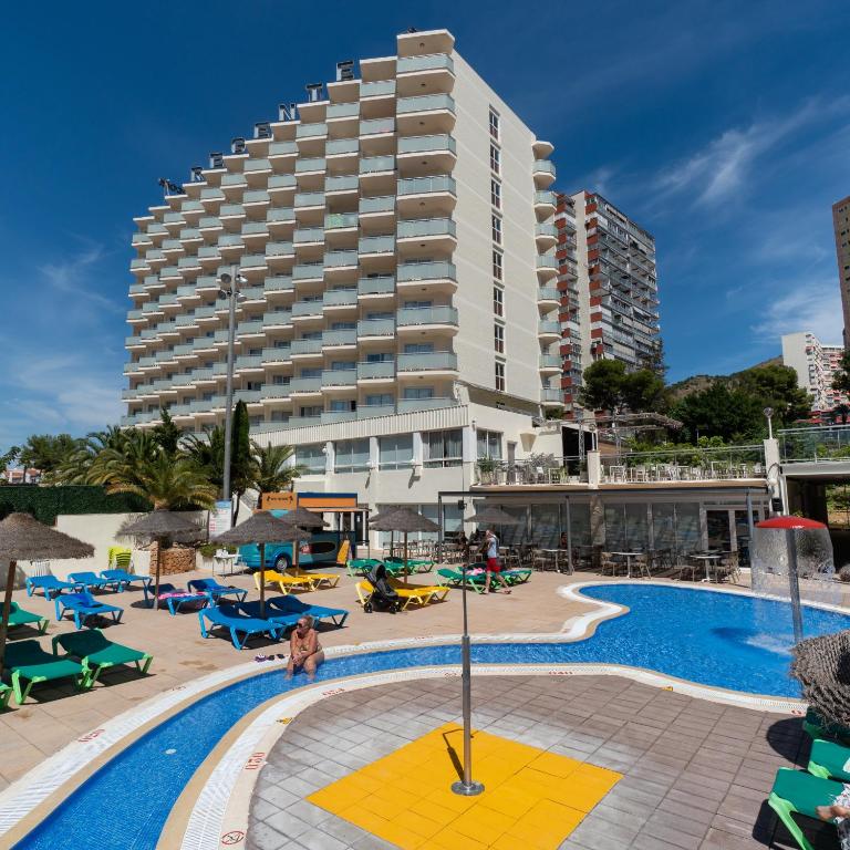 a hotel with a pool and a large building at Medplaya Hotel Regente in Benidorm
