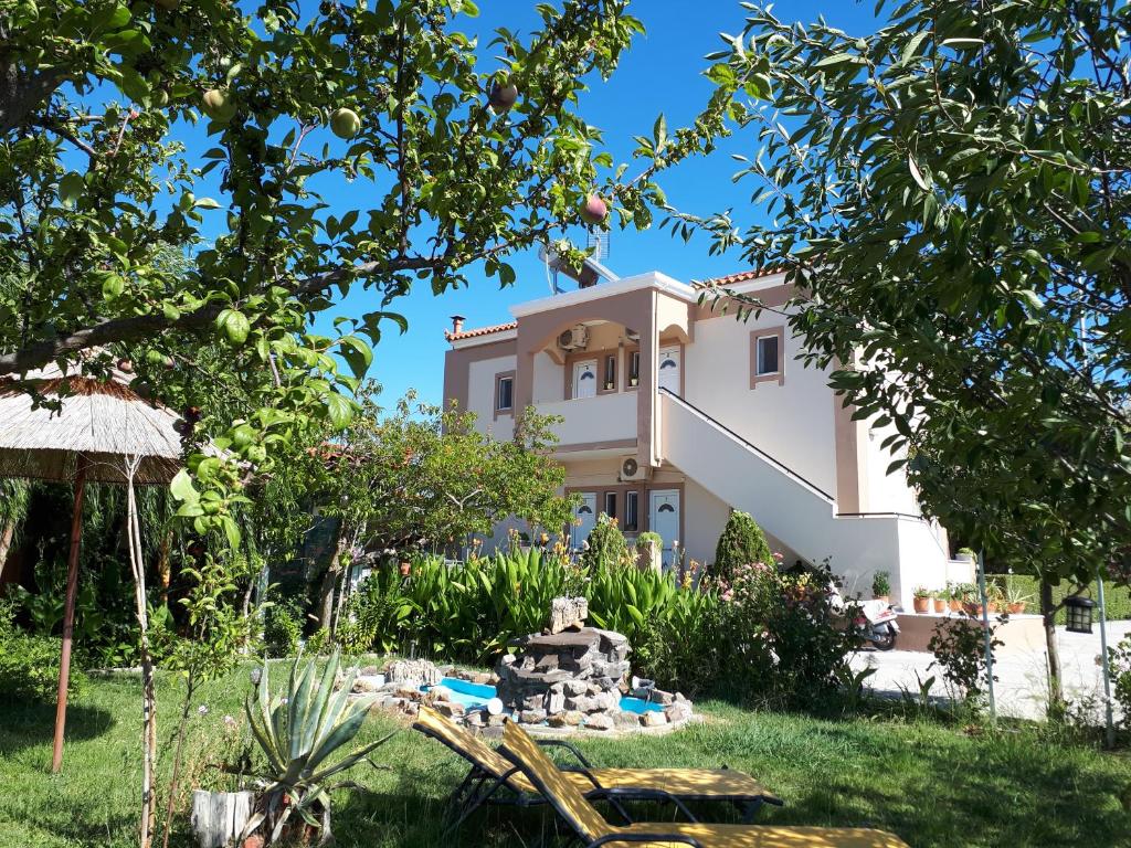 a villa in the middle of a garden at Shine Studios in Skala Kallonis