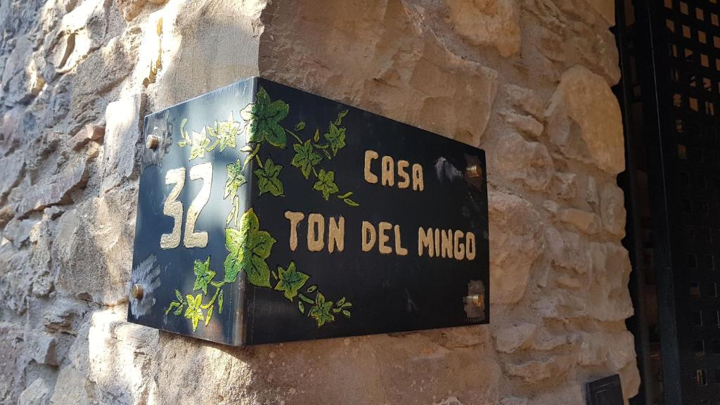una señal en el costado de una pared de piedra en Casa Ton del Mingo, en Sant Cerni