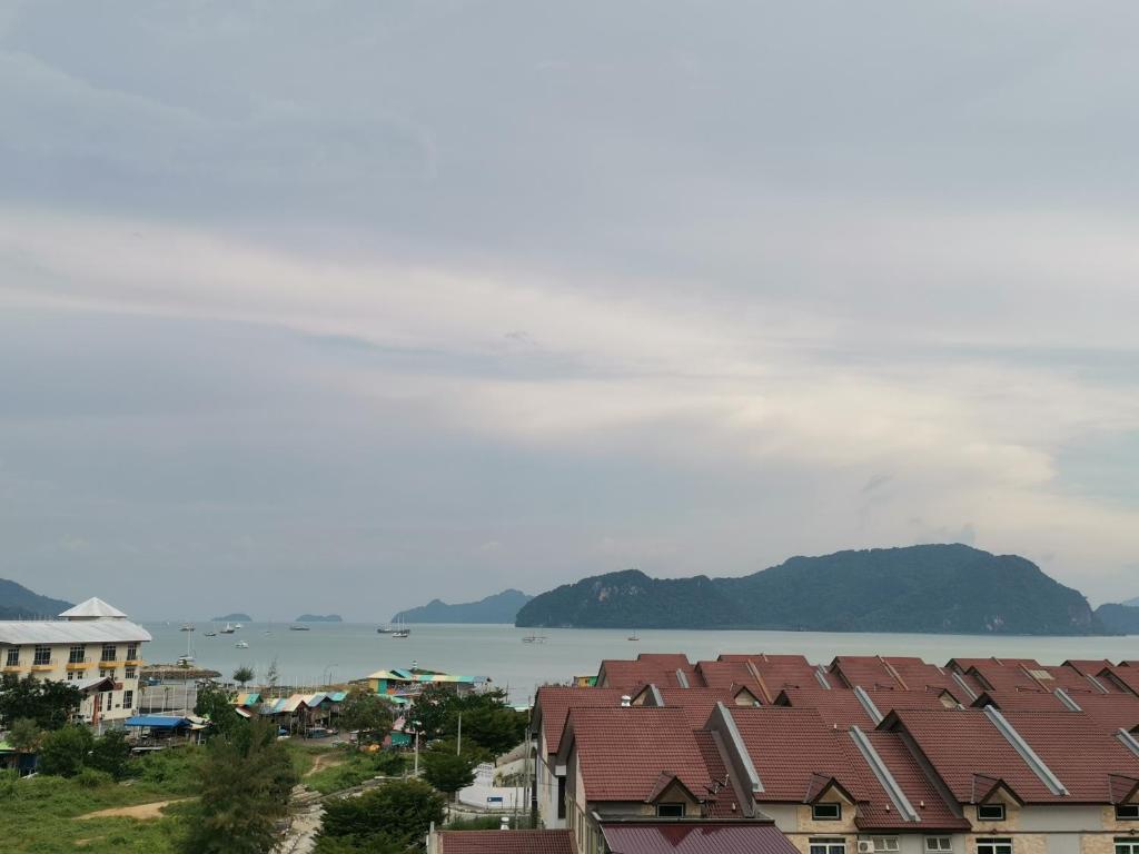 a view of a city with houses and the water at CD Seaview Apartment in Kuah