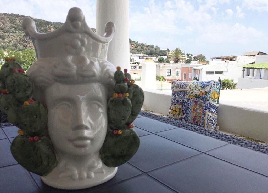 a statue of a head with cactus on a balcony at Roda' in Panarea