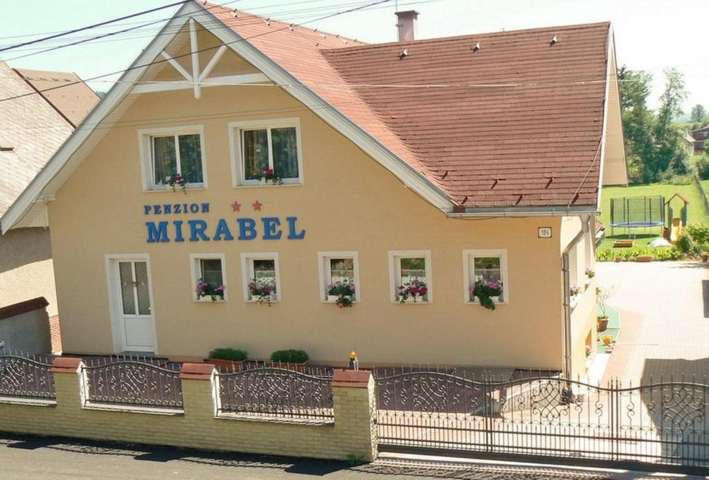 a building with a sign that reads national miracles at Penzion Mirabel in Bešeňová