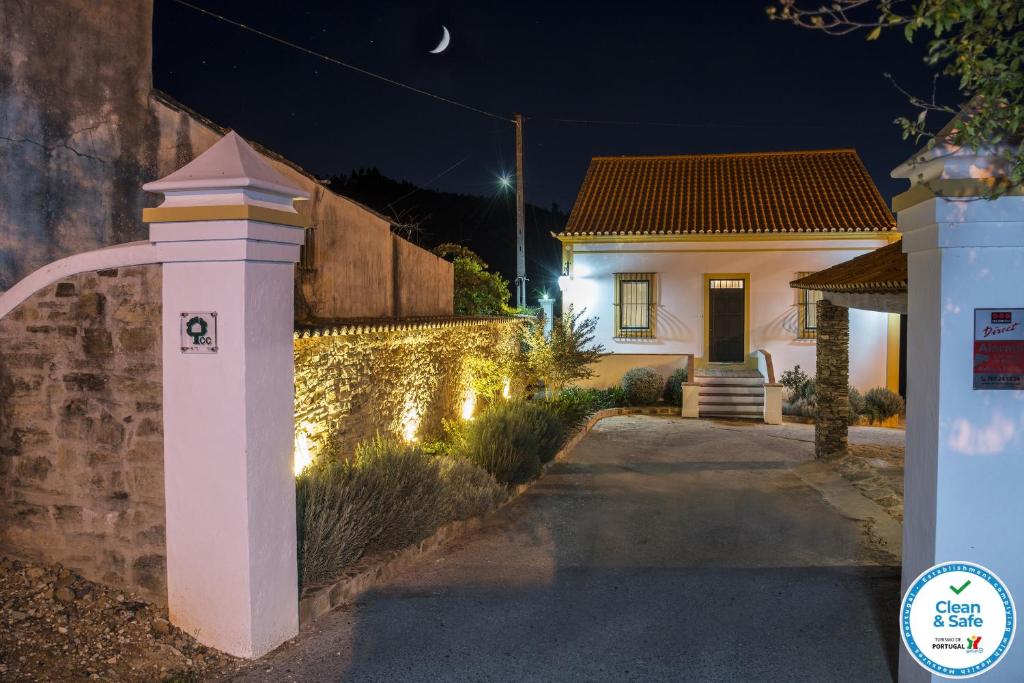 a house with a lighted driveway in front of it at Quinta da Eira Velha in Aldeia do Mato