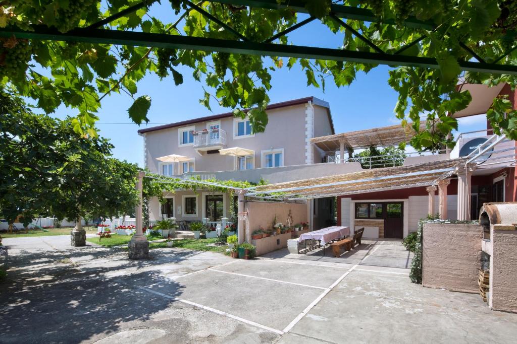 an image of a house with a parking lot at Apartments Al Parma in Budva