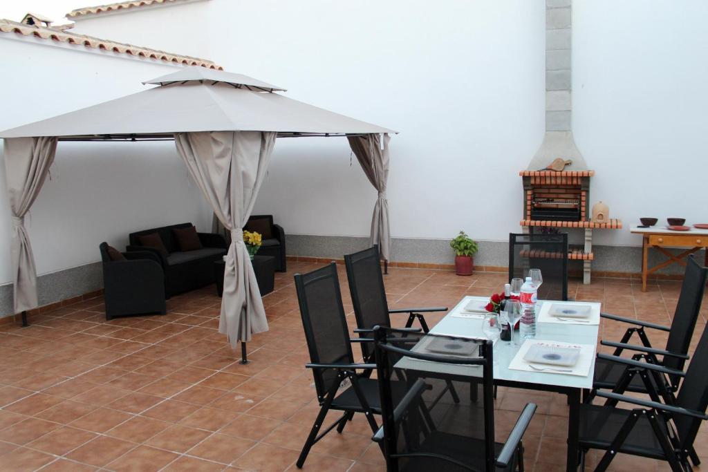 sala de estar con mesa, sillas y sombrilla en Casablanca de Almagro, en Almagro