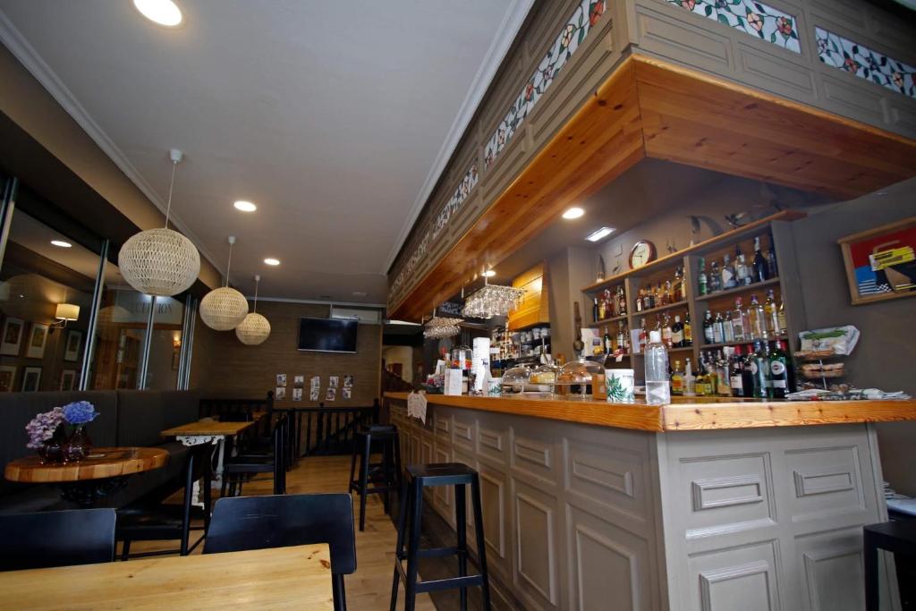 a bar in a restaurant with tables and chairs at Hotel Las Vegas in Colunga