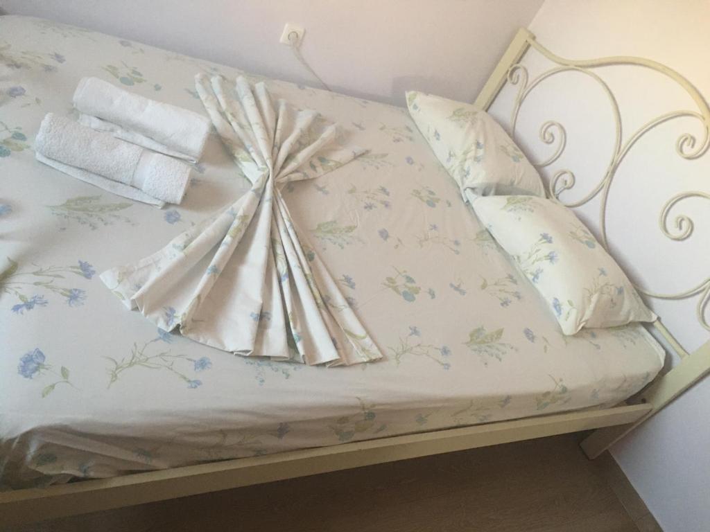 a bed with a blanket and pillows on it at Centrally Located Private Rooms in Heraklio Town