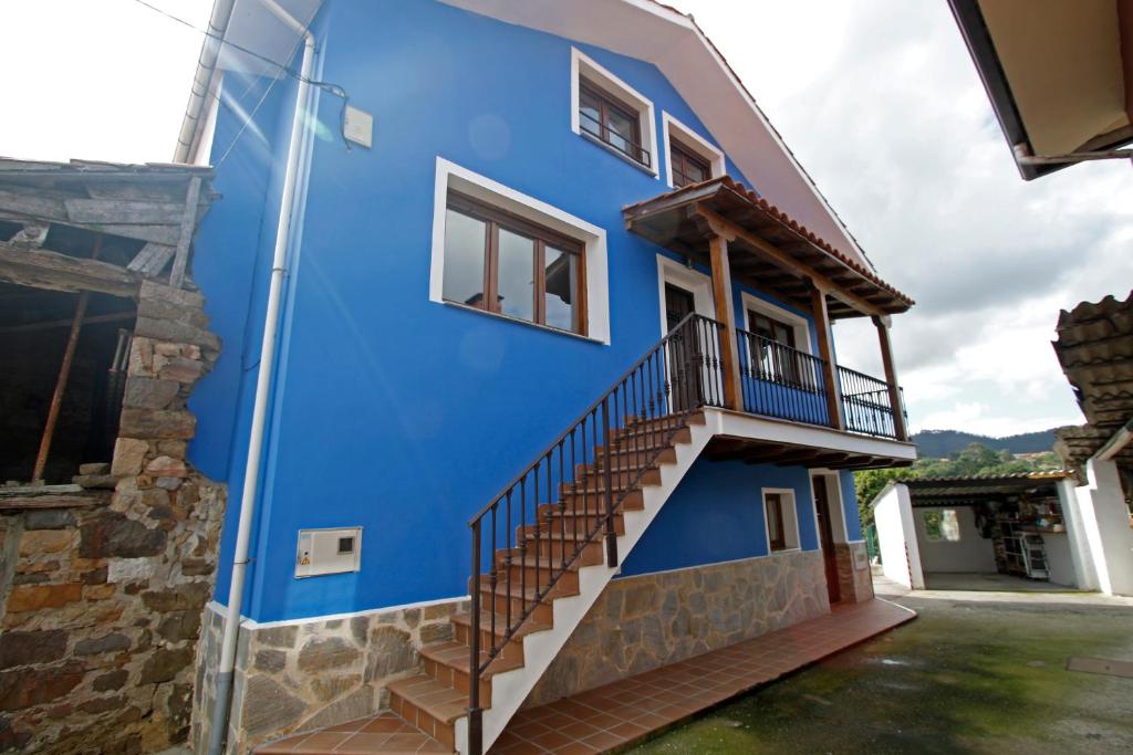 a blue house with stairs on the side of it at La casina de ribadesella in Ribadesella