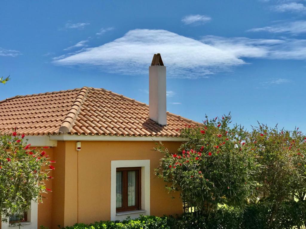 a house with a chimney on top of it at Boutique Hotel Ileas Village in Arkoudi