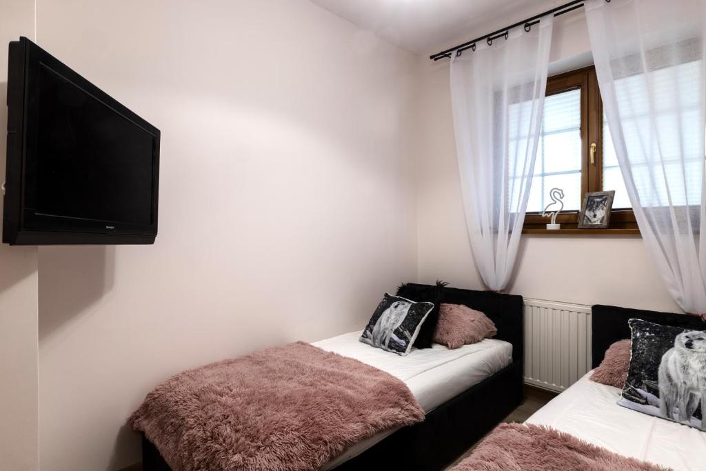 Postel nebo postele na pokoji v ubytování Apartamenty Tatrzańskie Turnie