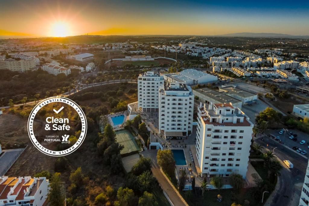 an image of a city with the clean safe logo at Janelas do Mar Apartamentos Turisticos in Albufeira