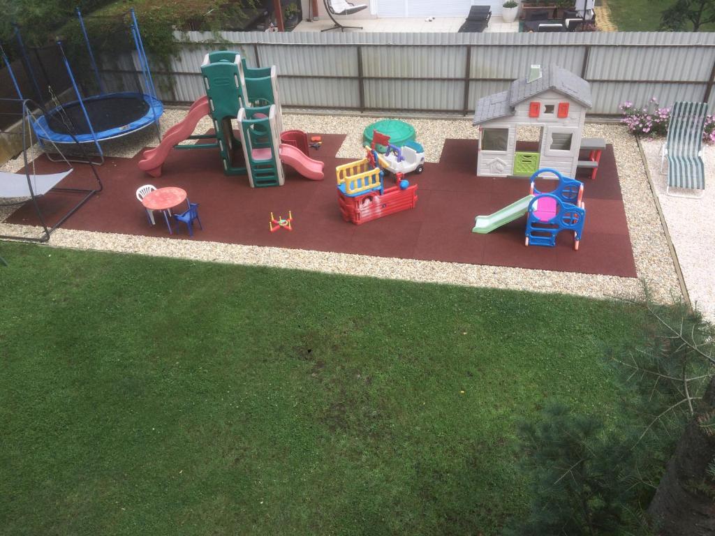 een speeltuin met speeltoestellen op het gras bij Apartman Luca in Nyíregyháza