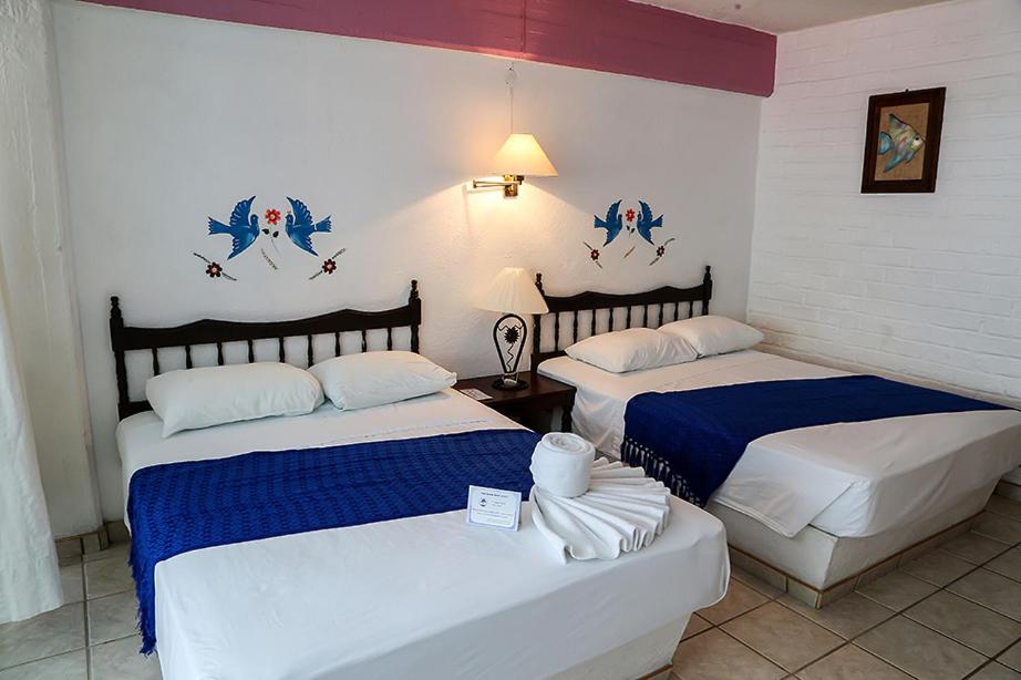 Postel nebo postele na pokoji v ubytování Vallartasol Hotel