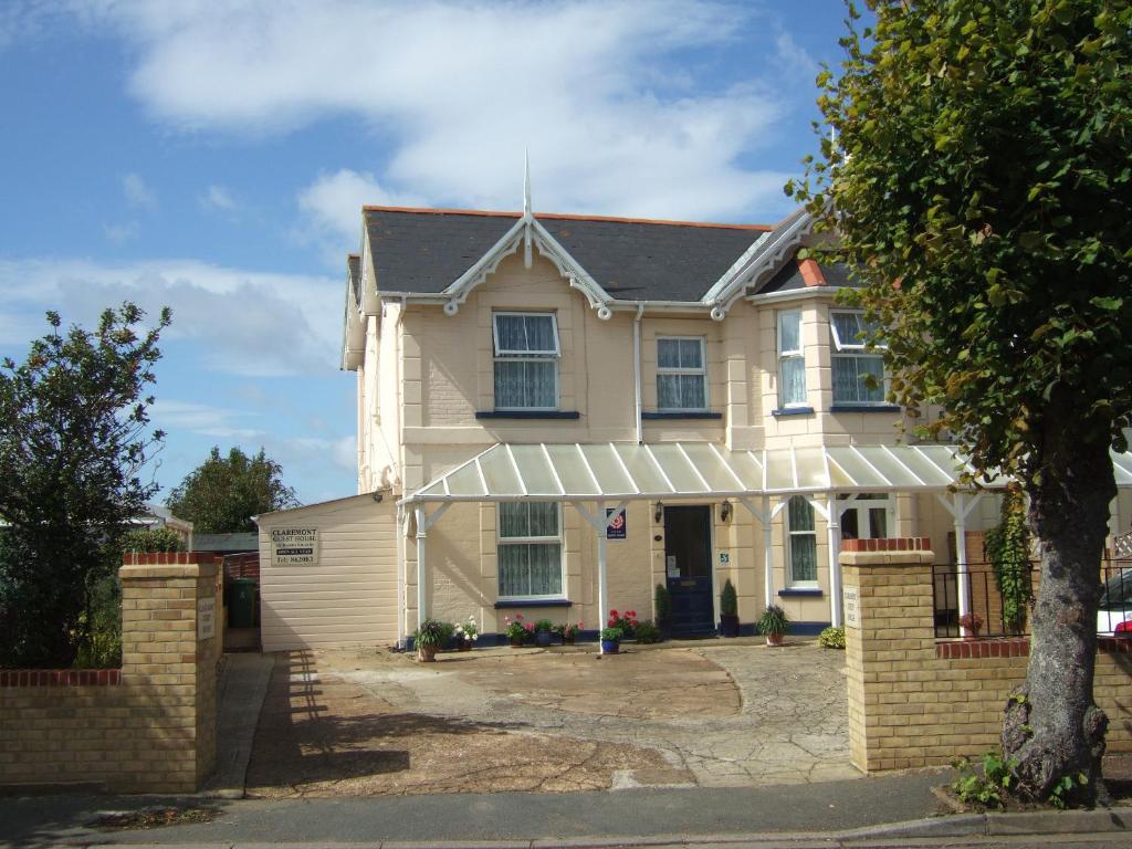 a large white house with a brick wall at Claremont in Shanklin