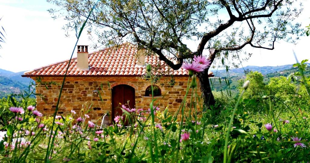 a small brick building in a field of flowers at Villa Nigro in Laureana Cilento