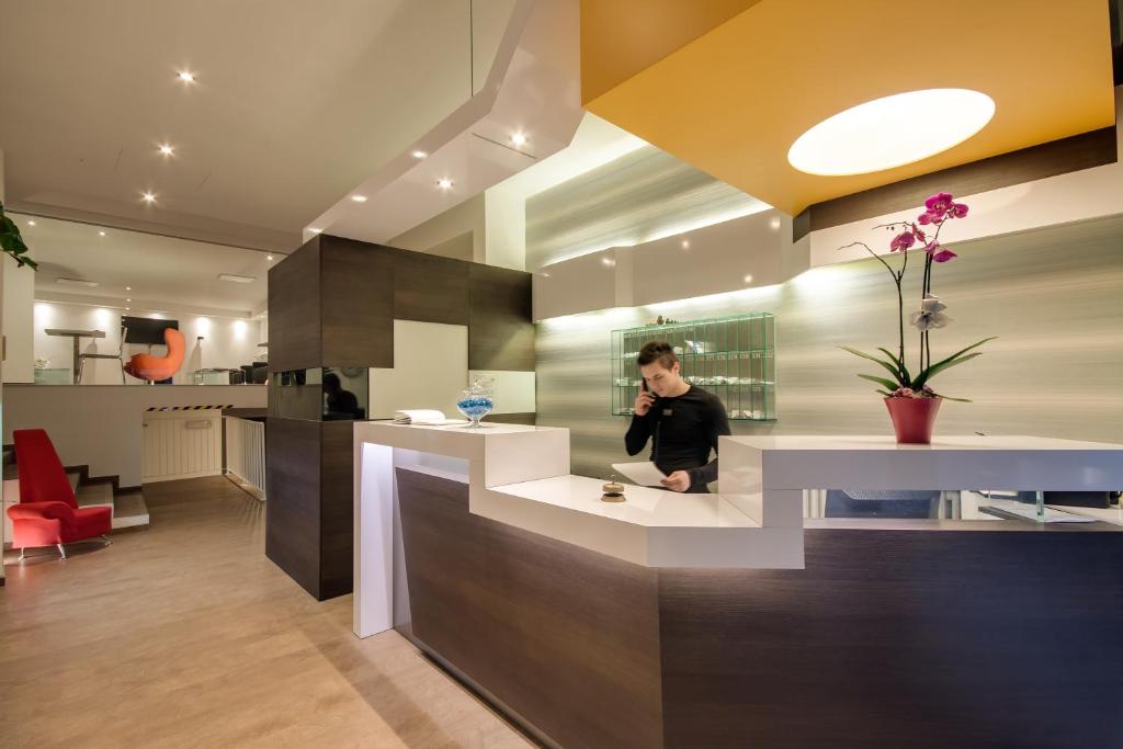 a man standing in a kitchen with a counter at Genius Hotel Downtown in Milan