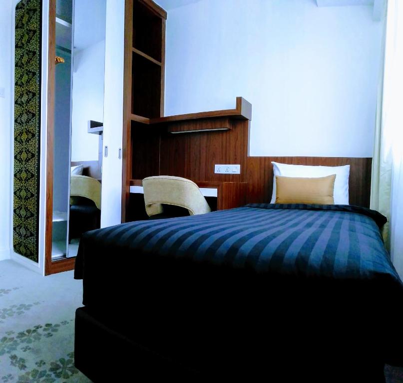 Postel nebo postele na pokoji v ubytování UTM Hotel & Residence