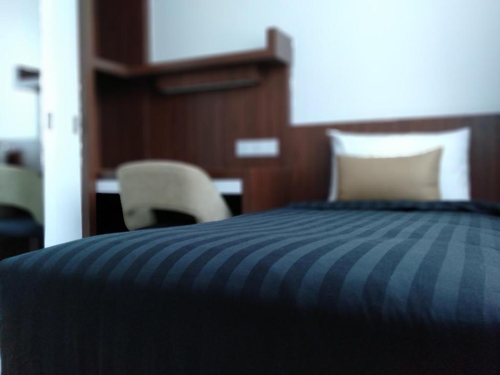 Postel nebo postele na pokoji v ubytování UTM Hotel & Residence
