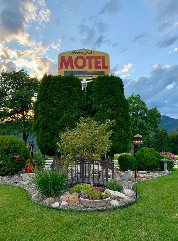 a motel sign in the middle of a garden at Arrow Lake Motel in Fauquier