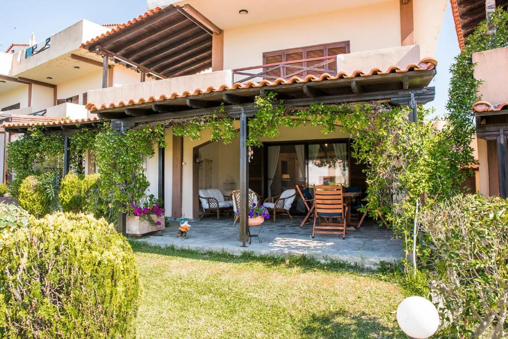 a patio in the backyard of a house at Eirinis House in Possidi