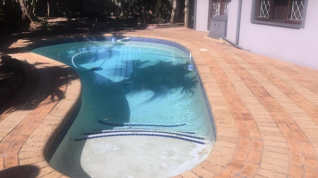 a swimming pool in the middle of a house at Nqabanqaba in Richards Bay