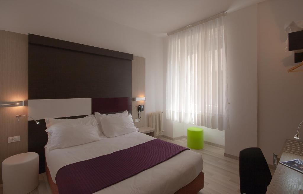 Postel nebo postele na pokoji v ubytování Genius Hotel Downtown