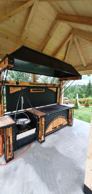 a grill under a pavilion with a roof at Lodge Nagramak in Sekulić 