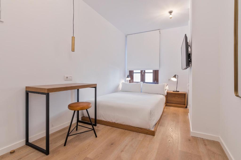 Postel nebo postele na pokoji v ubytování Uma Suites Atocha