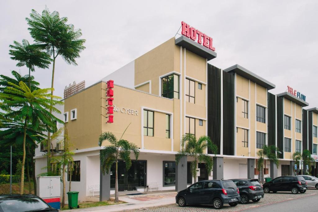 a building with cars parked in front of it at De Cyber Boutique Hotel in Cyberjaya