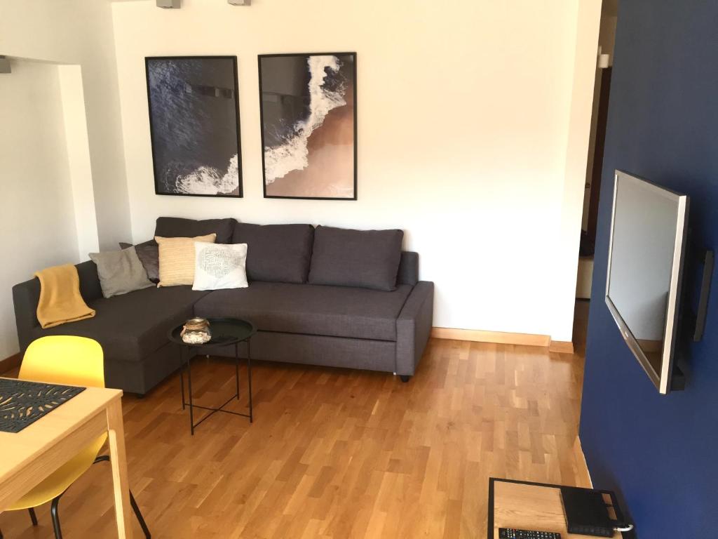 a living room with a couch and a table at Fregata Apartment Gdynia in Gdynia