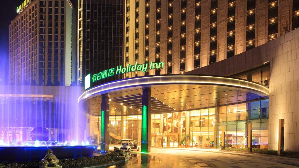 a large building with a sign on the front of it at Holiday Inn Nantong Oasis International, an IHG Hotel in Nantong