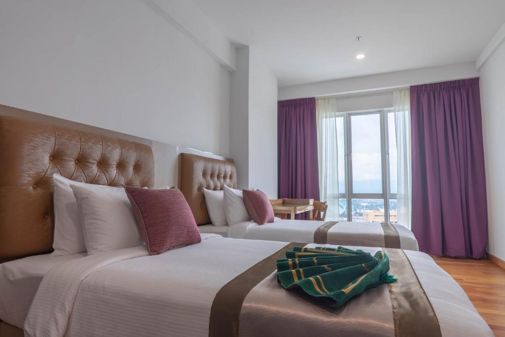 Katil atau katil-katil dalam bilik di Tamu Hotel & Suites Kuala Lumpur