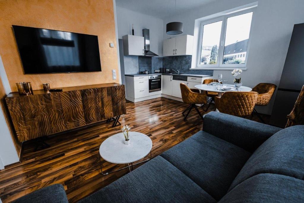 a living room with a couch and a table at Design-Appartement Steyr in Steyr