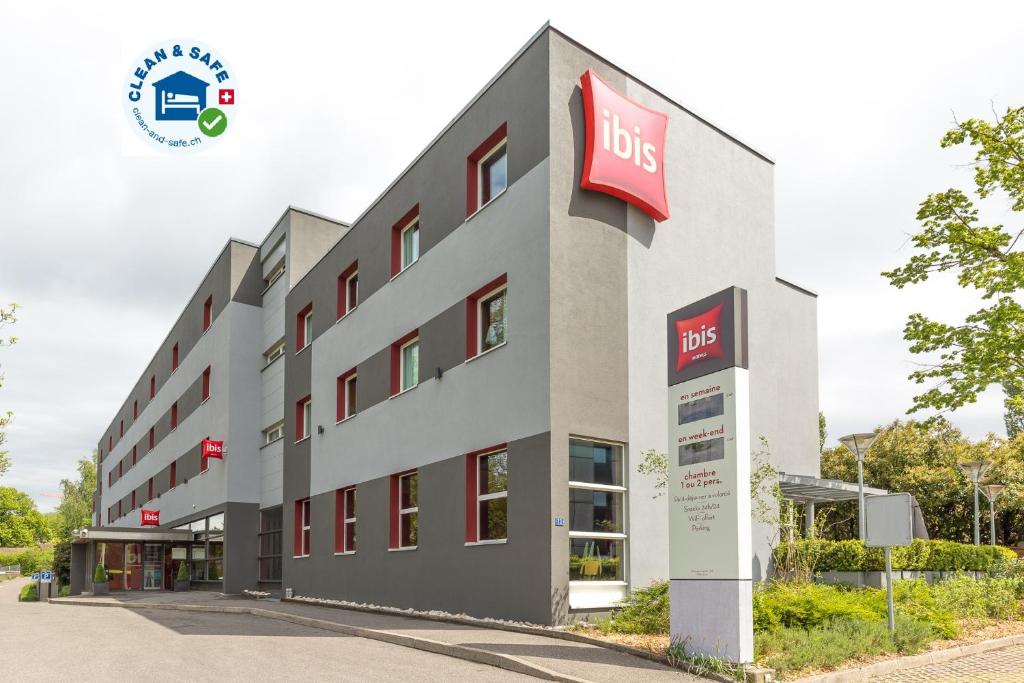 a building with a bus sign on the side of it at ibis Genève Aéroport in Geneva