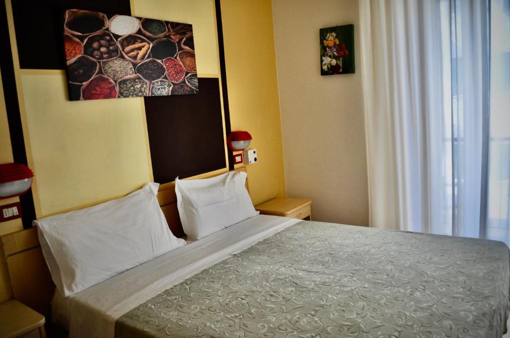 Postel nebo postele na pokoji v ubytování Hotel Corallo Garnì