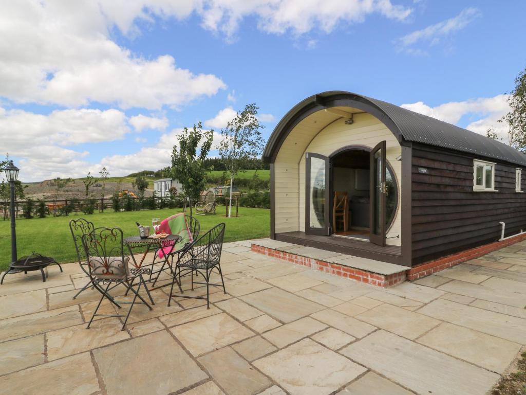 a small shed with chairs and a table on a patio at Valley View in Rhayader