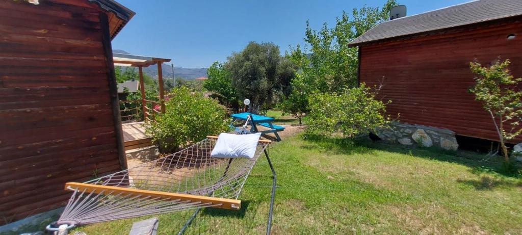 a hammock in a yard next to a house at Bahar Bahce Datca in Mesudiye