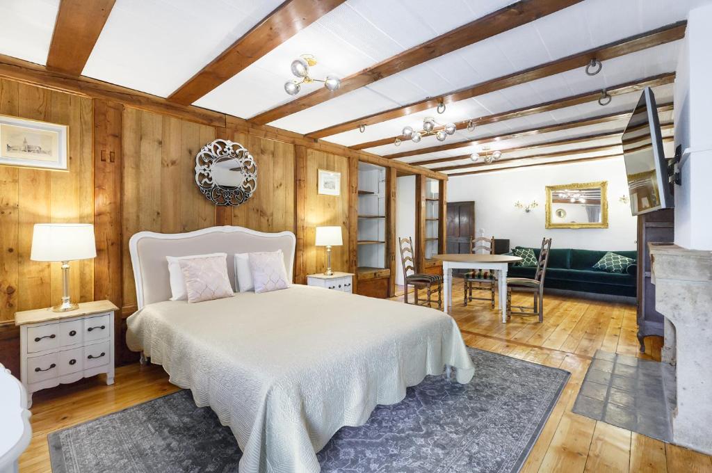 a bedroom with a bed and a table and chairs at A castle spirit apartment in Château du Châtelard in Clarens