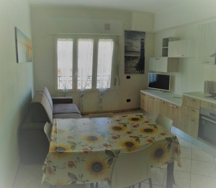 a kitchen with a table with a table cloth on it at Casa Maresole in Diano Marina